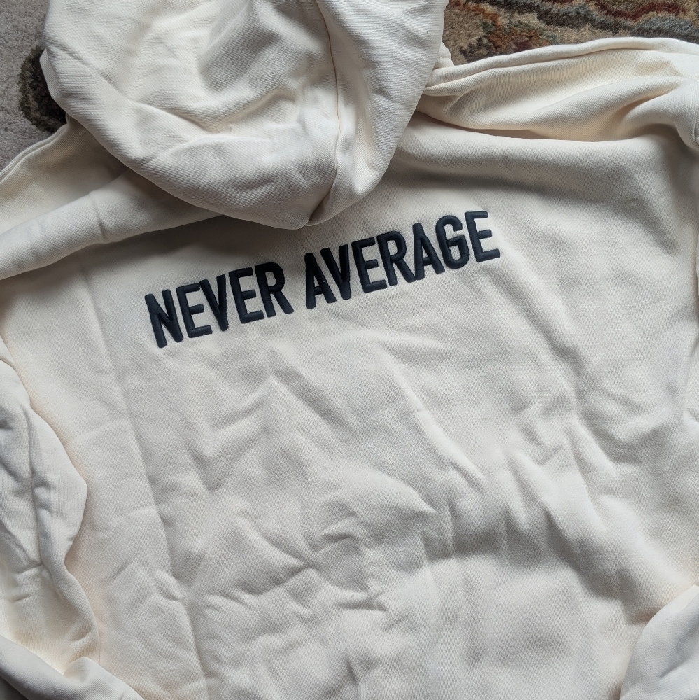 NEW WITH TAGS Wolfpak Cream Zip Hoodie with 'Never Average' Print